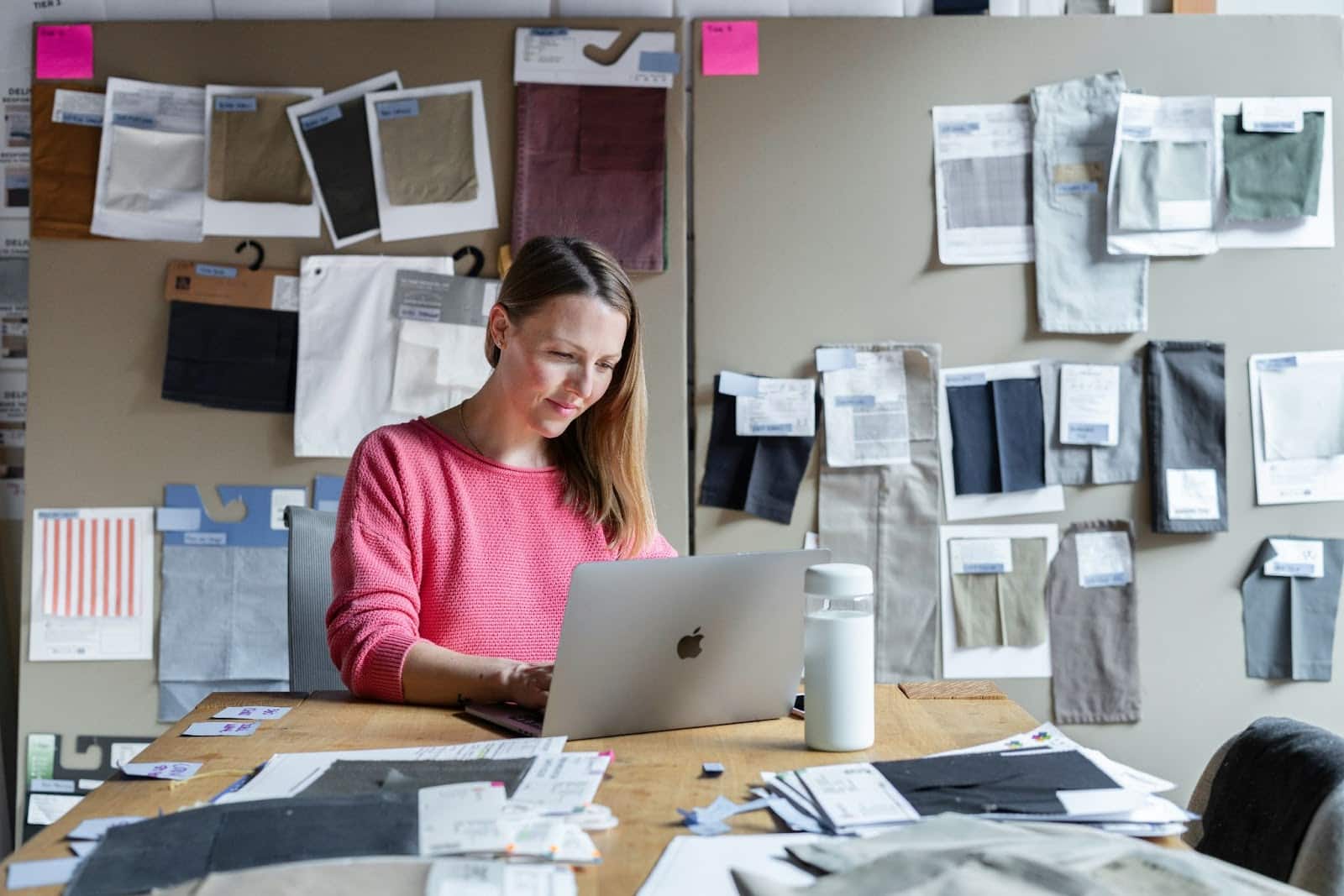 Focused woman working on a laptop at home, with signs of digital fatigue and increased cortisol levels from prolonged concentration and screen exposure.