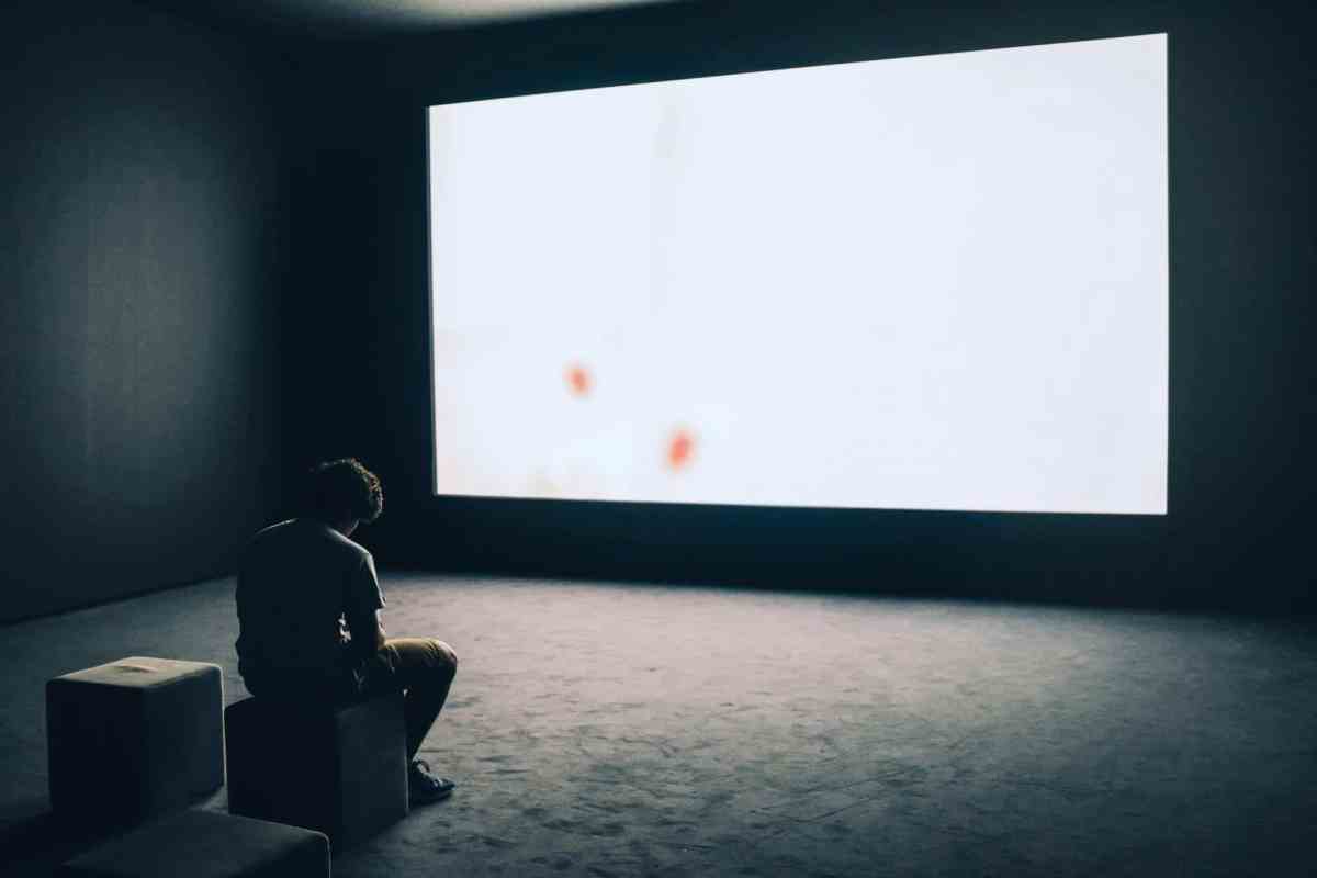Man staring at a glowing computer screen, showing overstimulation before starting dopamine fasting to reduce screen fatigue.