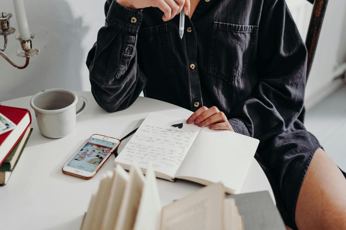 Person sitting thoughtfully – reflecting on personal goal setting strategies.